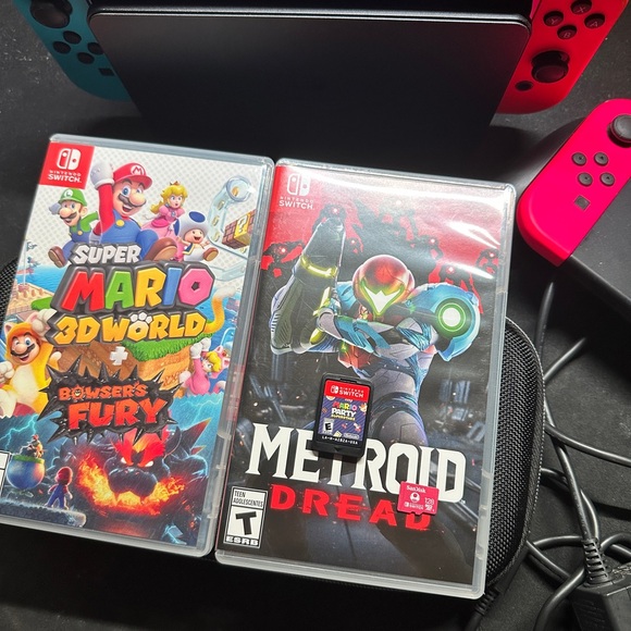 Switch Oled with: 

Mario Party
Metroid Dread
Mario 3D
Extra Joycon
128 GB SD